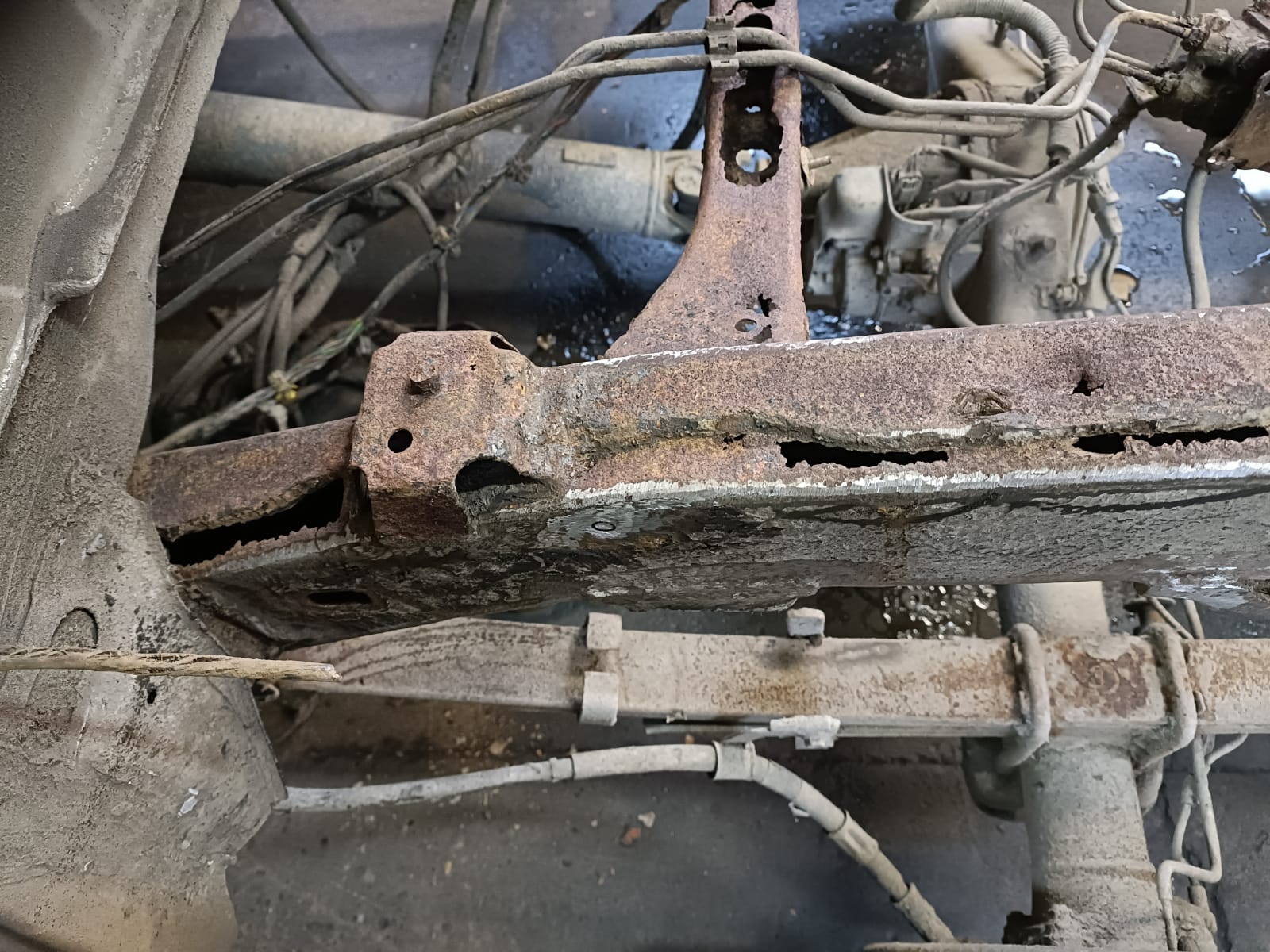 Chassis rails showing extensive perforation